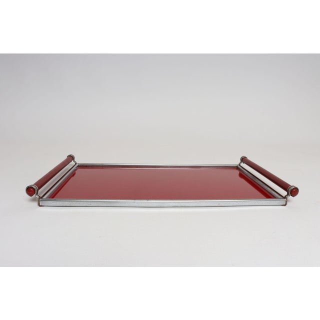 Art Deco tray composed of a glass-covered red laminate surface, painted red wooden handles and chrome borders/accents (ca....