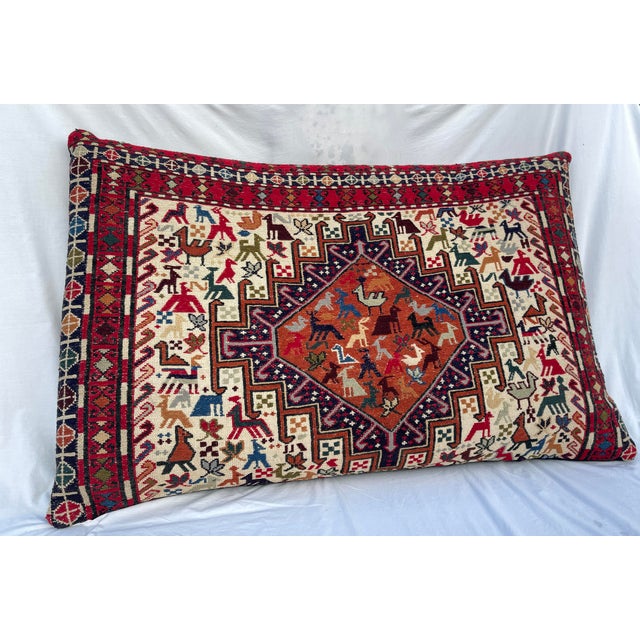 Large Caucasian Soumak wool rug pillow handwoven with animal motifs and tribal geometric patterns. Back side is made of...