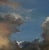 This oil painting captures a dynamic sky, where swirling clouds interact with a vibrant blue backdrop. The interplay of...