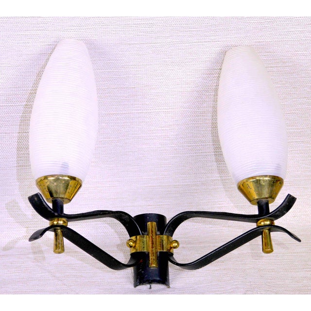 This is a classical Pair of Brass and black Sconces, from the French Maison Arlus, Mid century style and period. With the...