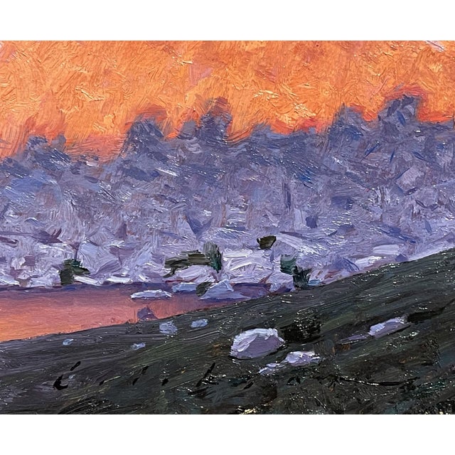 Paintbrush Divide captures a dramatic mountain landscape, where towering peaks bathed in warm hues contrast with cool,...