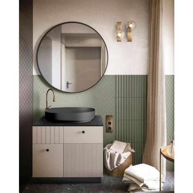 A single glass bubble alights upon a slender rectangle of brass for an essential design. Inspired by the sober...