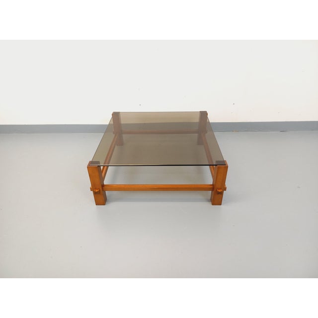 Vintage square coffee table from the 1970s, attributed to the Italian brand Fontana Arte. Beautiful design with a teak-...