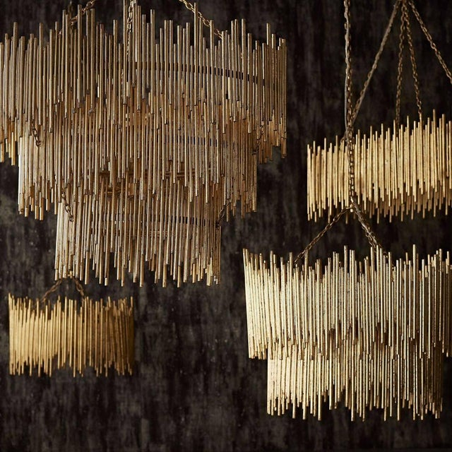Individual iron rods are welded together and hand-finished with gold leaf to create this striking three-light pendant....