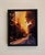 The artwork depicts a serene evening scene, where a warm golden light bathes the street and surrounding trees, creating a...