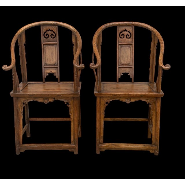 In the Ming style. A wonderful pair of antique carved Chinese chairs. Made of mixed woods finely carved horseshoe back...