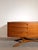 Exceptional vintage sideboard by beithcraft, crafted in beautifully grained teak wood and featuring an elegant sculptural...