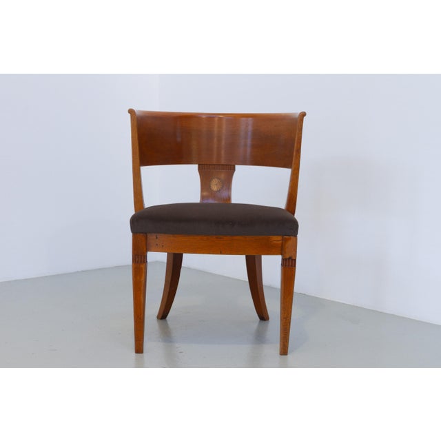 Charming antique armchair in solid Nordic oak with inlaid marquetry in the backrest and small carved detail son the legs....