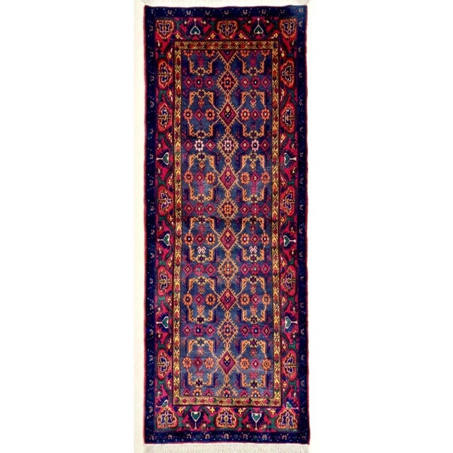 Hand-knotted runner from the Hamadan region of western Iran, featuring an allover geometric lattice design arranged in...