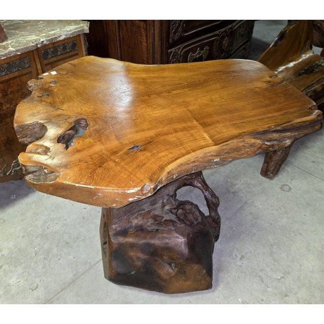 Solid wood carved table, crafted from a single piece of wood. Its organically shaped, natural tabletop and root-like...
