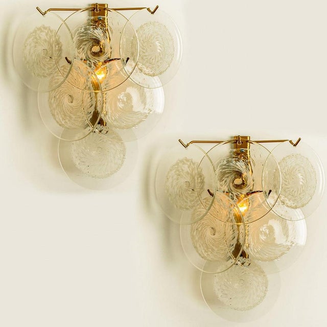 A gorgeous wall light, attributed to vistosi, italy, manufactured in circa 1960. Each lamp has six disks of clear murano...