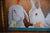 An original painting by Will Bullas: three white rabbits lined up at a bar, each with a glass of carrot juice, while a row...