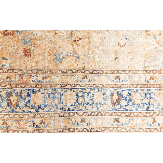 This antique Persian Tabriz rug, dating back to the early 20th century, is a distinguished offering from Doris Leslie...