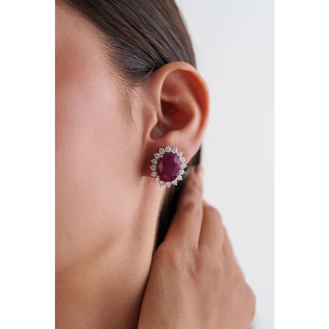 These Vintage-Inspired Stud Earrings features 18.91 carats Ruby, set in 14K white gold. Each ruby measuring approximately...