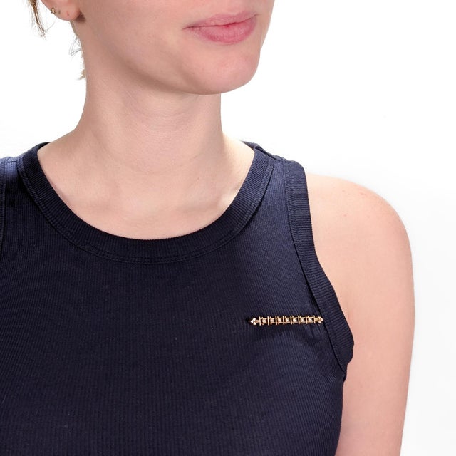 A fine Aesthetic Movement bar pin or brooch. In 14k gold. Centered on a row of bezel set seed pearls in an openwork matrix...