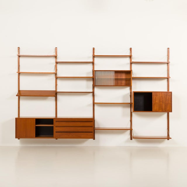 This danish vintage teak wall unit was designed by poul cadovius and made by cado in the 1960s. It is one of a very few so...