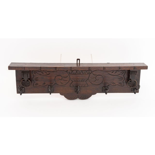 Arts and Crafts Oak Wall-Hanging Coat Rack, with carved scroll and bouquet motif with wrought iron hooks and two ring...