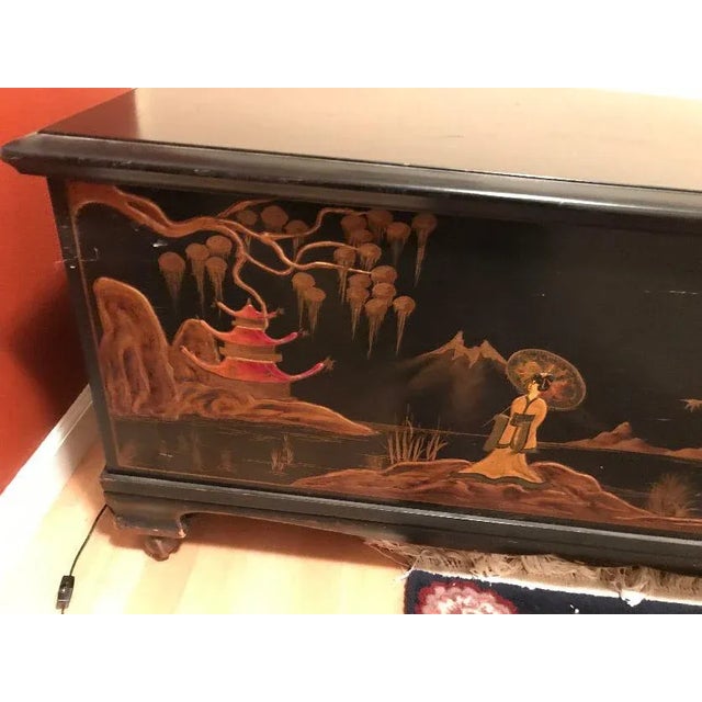 Bring a beautiful piece of Asian art-covered furniture into your home. Antique blanket trunk acquired in 1920s. Black...
