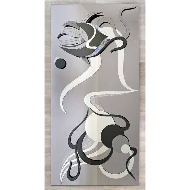 A contemporary modern abstract wall hanging mirror. This piece features a beautiful abstract modernist patterning with...