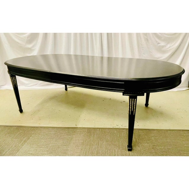 Maison Jansen Style Dining Table in Louis XVI Style having a semi gloss matt finish with bronze mounts. This antique...