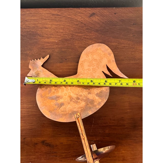 Add a touch of rustic charm to your walls with this vintage hand-hammered copper rooster wall sconce, a beautifully...