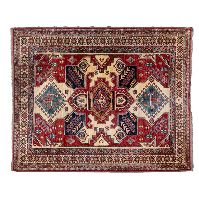 Hand-knotted wool rug from the 20th century. The composition is dominated by a distinctive stepped medallion surrounded by...