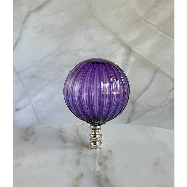 Oversized glass lamp finial crafted from a handblown glass bubble. Each has a vertical striped pattern and a ribbed...