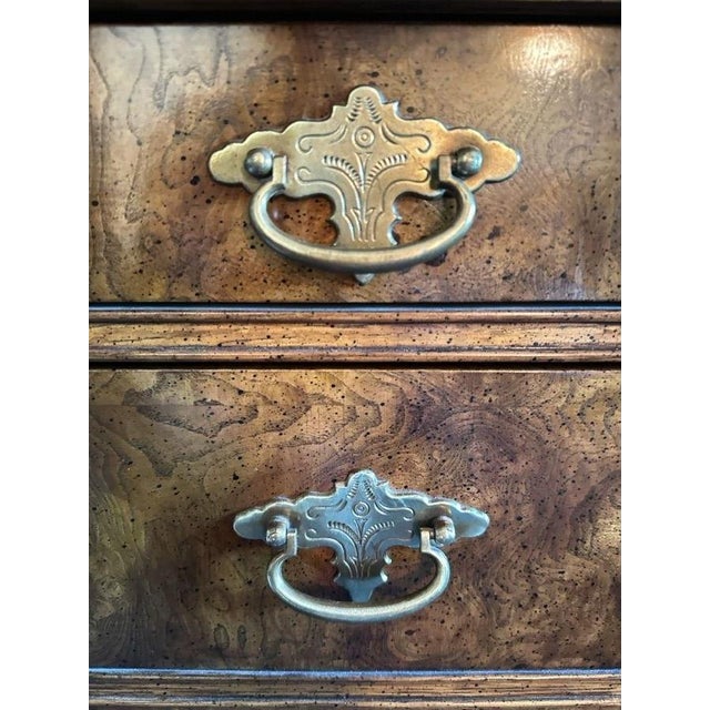 A National Mt. Airy campaign-style desk with dramatic burlwood grain, brass hardware and multiple smoothly gliding...