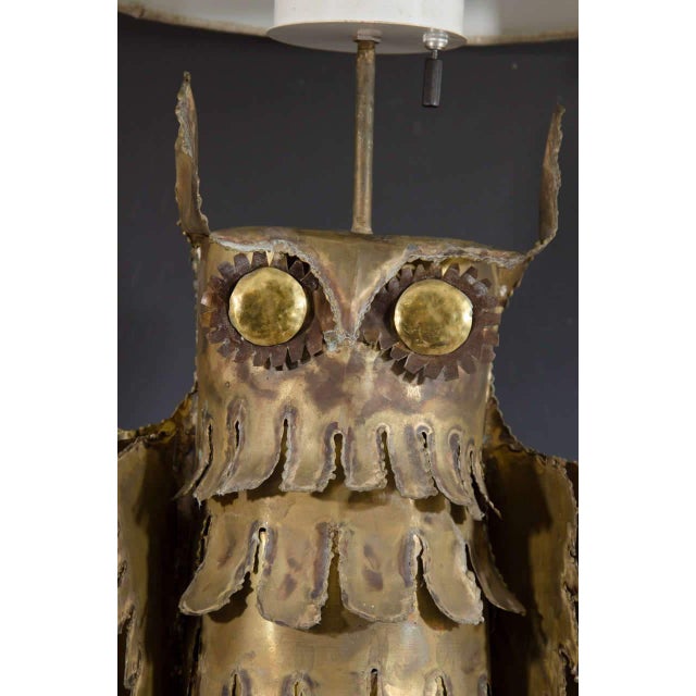A Mid-Century Brutalist table lamp depicting an owl perched on a branch. The lamp sits on an 8" X 8" X 3/4" travertine...