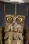A Mid-Century Brutalist table lamp depicting an owl perched on a branch. The lamp sits on an 8" X 8" X 3/4" travertine...