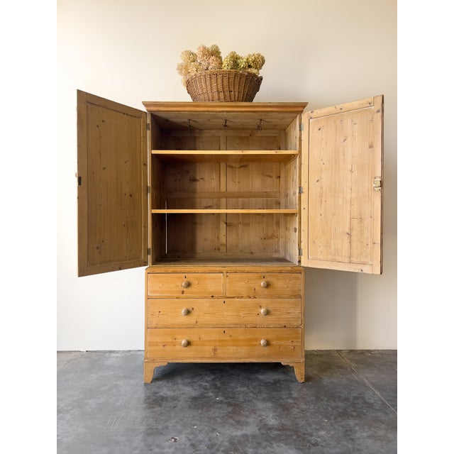 An immaculate antique English pine linen press, expertly restored and freshly waxed to highlight the beautiful wood grain....