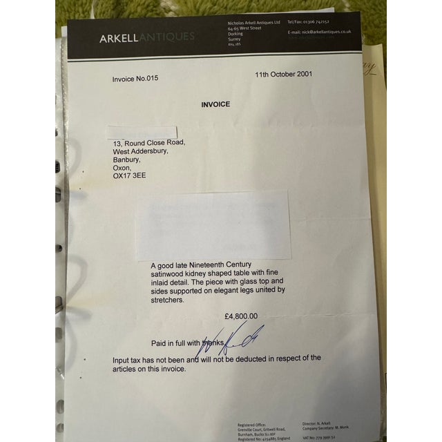 A beautiful late 19th Century satinwood kidney shaped table with fine inlaid detail. The piece with glass top and sides...