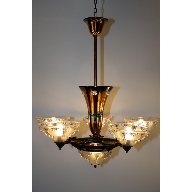 Large, copper-plated chandelier in very good condition for its age. The chandelier was completely redesigned and the...