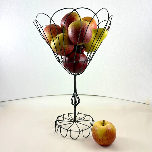 From France, circa 1890-1910, a petal top, twisted black metal wire standing basket, over 16 inches tall. Amazing as a...