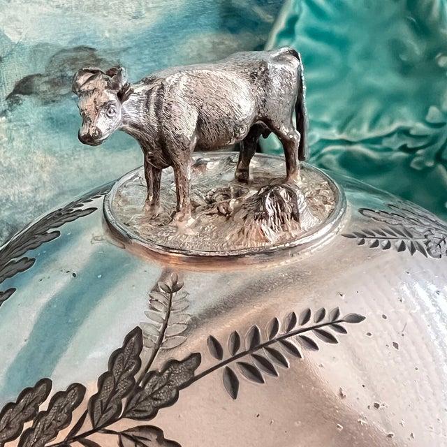 Transform your dining table with the Antique Victorian Quadruple Silverplate Butter Cooler, featuring an exquisite cow...