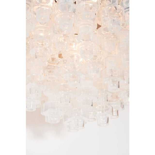 This outstanding Murano glass chandelier, in the manner of Carl Fagerlund, features numerous barbell shaped Murano glass...