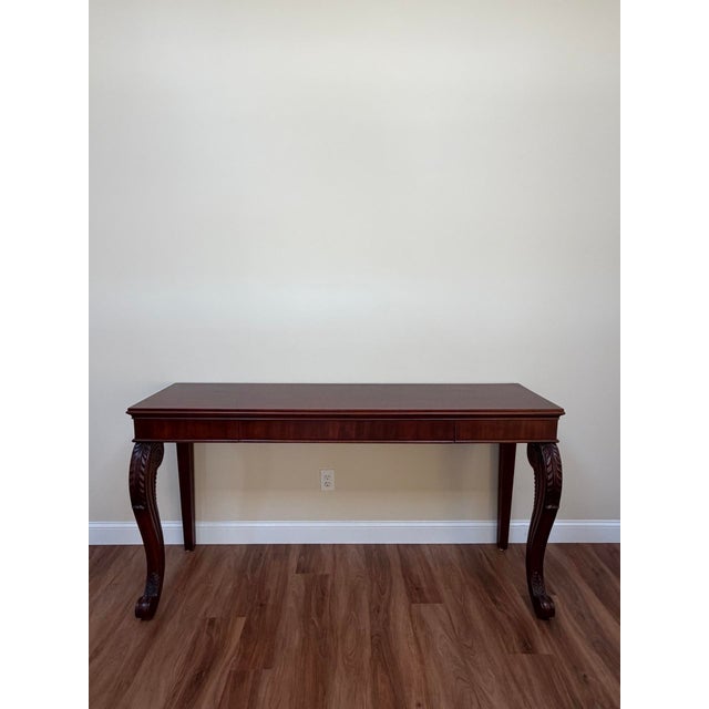 Regency-inspired foyer/console table by Polo Ralph Lauren, crafted in richly finished mahogany with sculptural carved...