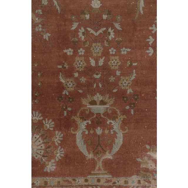 Hand-knotted in wool, this oversized 11x15 antique Lahore rug dates to circa 1900-1920. The design showcases an elegant...