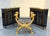Pair of Baker Furniture Neoclassical Black Lacquer and Gilt Cabinets, distinguished by elegant architectural proportions,...