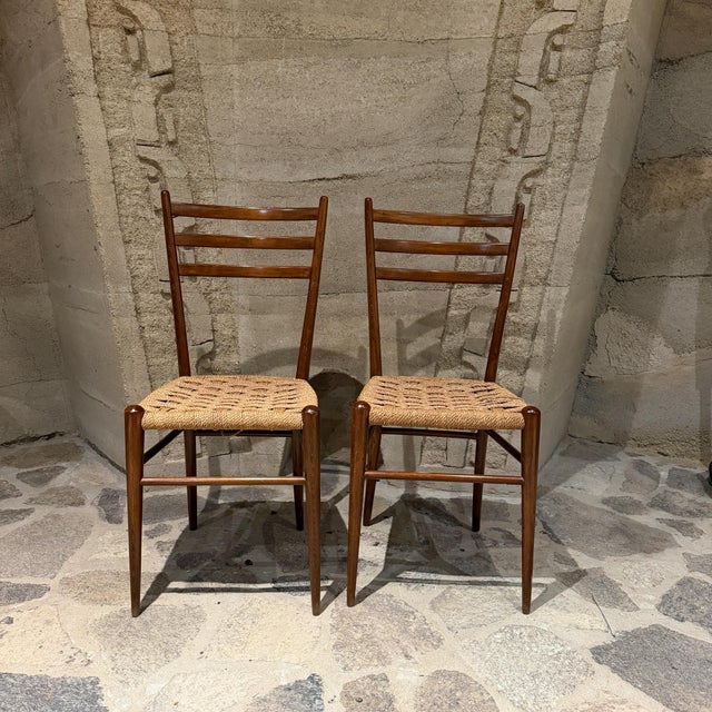 For your consideration a pair of vintage Italian mid-century modern ladder-back side chairs in the style of Gio Ponti,...