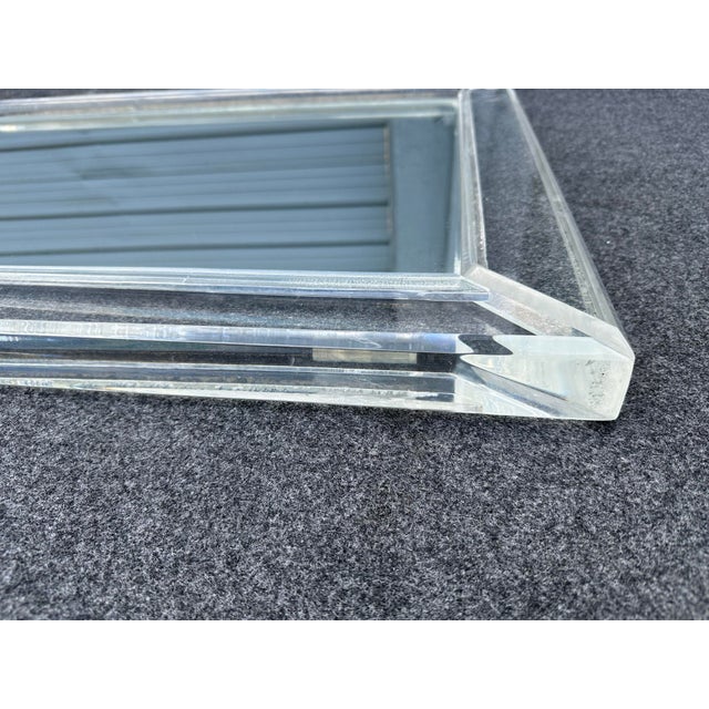 Vintage lucite wall mirror, in Karl Springer style. It is in very good condition, very good quality.