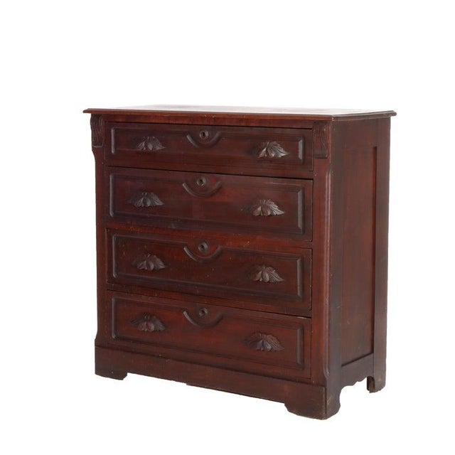 Antique Walnut 4-Drawer Dresser With Carved Pulls C1890 Measures - 39 1/4" x 40 1/8" x 18 1/2" An antique walnut dresser...