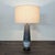This Currey & Company table lamp features a sleek ceramic base with a gray and white gradient finish and a sturdy round...