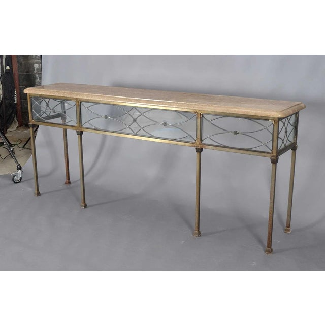 A custom-built modern steel console table on six legs. The thick (1 1/2") stone top has an ovolo molded edge. The frieze...