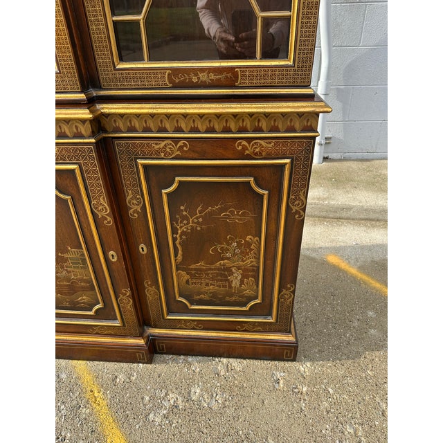 Kindel Furniture Hand-painted breakfront with Chinoiserie scenes adorning the lower doors, depicting landscapes and...