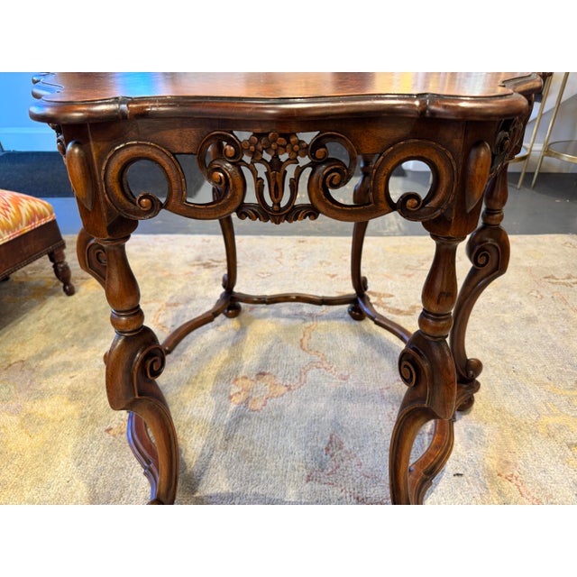 This is a 1930s French Walnut Center table. It is Louis XV Rococo style. It has a unique style shape and has an opening on...