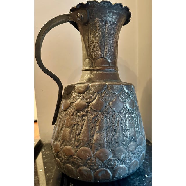 This beautiful antique Middle Eastern water pitcher is a stunning piece of metalware, crafted from dovetailed copper with...