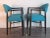 This pair of armchairs features blue fabric seats and dark stained beech frames. This piece is attributed to the mentioned...