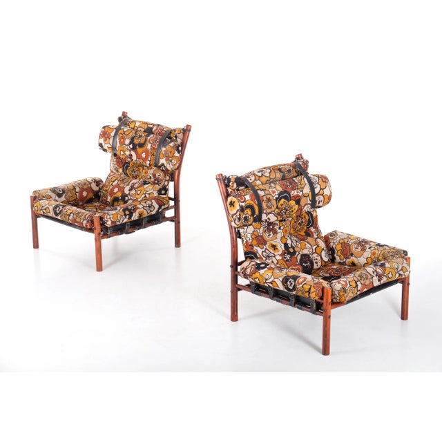 A pair of the very comfortable Inca chair with patinated original leather and original fabric. Designed by Arne Norell,...