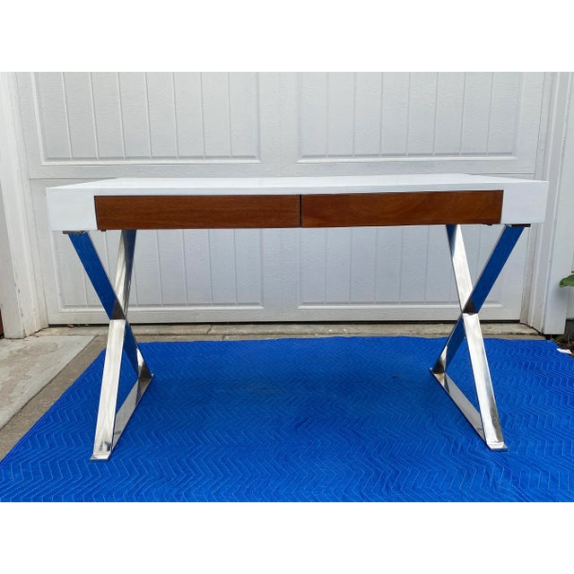 Contemporary modern chrome desk with X base, white top, and two mahogany drawers. Recently completely refinished. In the...